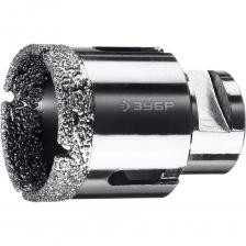 Коронка алмазная вакуумная ЗУБР Профессионал Технология ВВС (Высокотемпературное Вакуумное Спекание алмазов) позволяет работать алмазным инструментом без применения водяного охлаждения и сверлить самые твердые материалы. Предназначена для сверления отверстий в керамограните, камне, керамике, бетоне, кирпиче, ограниченно в листовом металле, дереве и комбинаций всех этих материалов. Используется на УШМ. Внимание, изображение товара может отличаться от реального! Верные параметры указаны в технических характеристиках товара. Коронка алмазная вакуумная ЗУБР Профессионал Технология ВВС (Высокотемпературное Вакуумное Спекание алмазов) позволяет работать алмазным инструментом без применения водяного охлаждения и сверлить самые твердые материалы. Предназначена для сверления отверстий в керамограните, камне, керамике, бетоне, кирпиче, ограниченно в листовом металле, дереве и комбинаций всех этих материалов. Используется на УШМ. Внимание, изображение товара может отличаться от реального! Верные параметры указаны в технических характеристиках товара.