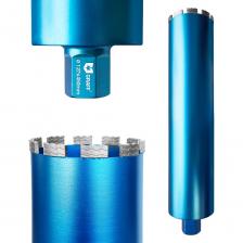 Коронка алмазная 127x12 мм 1 1/4" GRAFF для сверления бетона и армированного бетона при помощи установки алмазного бурения. Турбо сегменты длинной 20 мм с зубчатой кромкой на окончании обеспечивают высокую скорость сверления и делают коронки пригодными для резки арматуры. Данная коронка подходит как для сухой, так и мокрой резки. Сегменты прикреплены к телу коронки методом лазерной сварки. Параметры алмазной коронки по армированному бетону: диаметр коронки - 127 мм; длина тела коронки - 450 мм; высота сегмента - 12 мм; ширина сегмента - 24 мм, толщина сегмента 3,5 мм, количество сегментов – 10. Алмазная коронка может самозатачиваться за счет истирания слоя алмазной крошки во время работы. Пригодна для работ на следующем оборудовании: установки для алмазного сверления; установки для алмазного бурения; алмазные сверлильные установки; сверлильные машины по бетону; алмазные дрели; алмазные установки для бурения бетона; дрели для алмазного сверления.