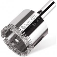 Алмазная коронка MKSS с центрирующим сверлом предназначена для аккуратного выполнения отверстий в материалах, таких как керамика, кафель и стекло. Ее рабочая часть покрыта алмазами, что гарантирует высокую эффективность и отличное качество реза. Коронка с цилиндрическим хвостовиком совместима с быстрозажимными и ключевыми патронами электроинструментов. Для охлаждения и удаления шлама во время работы необходимо использовать воду, это также поможет избежать перегрева инструмента. Важно отказаться от ударного режима и внимательно контролировать скорость вращения, чтобы обеспечить оптимальные условия для сверления. Поставляется с шестигранным ключом и центрирующим сверлом. Внимание, изображение товара может отличаться от реального! Верные параметры указаны в технических характеристиках товара.