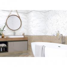 Коллекция Tokio с глянцевой поверхностью рекомендована для облицовки стен ванной комнаты, санузла, фартука кухни. Удобный формат плитки 200х600 мм. Комплектуется платиновым металлическим стиком из нержавеющей стали 12х600 мм и матовым ректифицированным керамогранитом для пола форматов 600x600 мм и 200x900 мм. Ректифицированный край керамогранита позволяет сделать укладку с минимальным швом. Страна производства — Россия, бренд Alma Ceramica. Коллекция Tokio — воплощение элегантного минимализма. Серия содержит пять элементов, три из которых выполнены с рельефом «шеврон». Плитка с глянцевой поверхностью формата 200x600. Теплый цвет древесины гармонично сочетается с холодной текстурой натурального мрамора. Незаменимой деталью коллекции стал центральный элемент «шевронов» — микс дерева и мрамора, который создает плавный переход между остальными элементами. Все элементы коллекции продаются квадратным метром. Эффектный глянцевый, серебристый бордюр 12x600 гармонично завершает образ коллекции. В качестве напольной плитки предложен керамогранит с текстурой дерева 200x900 и матовый ректифицированный керамогранит 600x600 со структурой мрамора Carrara.