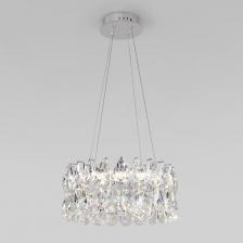 Выразительная люстра Strotskis преобразит потолочное пространство и создаст в вашем помещении полноценное освещение на площади 12 м кв. Декоративные хрустальные пластины, со встроенными LED, переливаются на свету искристыми завораживающими бликами. В производстве подвесной люстры использовали особое стекло с эффектной огранкой и высококачественный металл с надежным защитным покрытием.