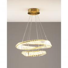 Подвесная люстра Asti в современном стиле. Металлический каркас золотого цвета дополнен вставками из прозрачного хрусталя, которые создают изумительную игру света при освещении. Стильный дизайн люстры дополнит любой современный интерьер. С площадью освещения 22 кв. м люстра станет идеальным выбором для больших комнат, а также для обеденной зоны или зала. В качестве источника света используется LED лента мощностью 80 Вт. При необходимости высоту люстры можно отрегулировать с помощью подвесной цепи.